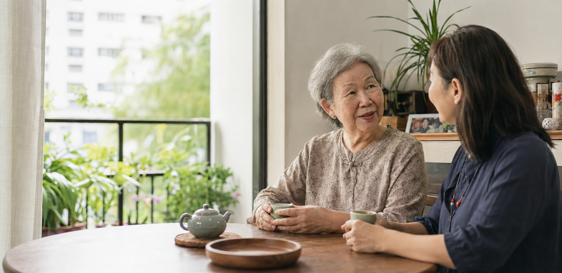 一位长者与女儿在新加坡家中喝茶交谈